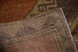 Vintage Oushak runner reverse, showing tight weave, secured side, and distressed copper pile.