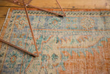 Worn texture of distressed Oushak carpet with faded tangerine, royal blue, mint green.