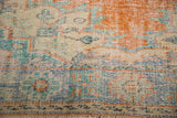 Distressed vintage Oushak carpet pile showing visible knot heads and faded tangerine, blue, and ivory.