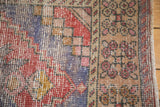 Distressed vintage Oushak runner detail: stepped spandrel, inner border, and fringe.