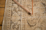 Distressed vintage Oushak carpet pile showing worn knot heads and earthy neutral tones.