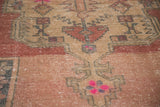 Distressed Oushak rug with geometric motifs, faded blush, rose, ivory, and bubblegum pink.