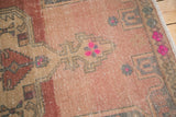Even wear on distressed pile of vintage Oushak rug with blush and bubblegum pink geometric patterns.