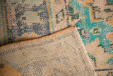 Distressed hand-knotted pile with exposed knot heads and backing of a vintage Turkish Oushak rug.