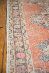 Vintage Oushak runner, distressed apricot pile showing foundation, with ivory and pink floral border.