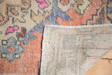 Distressed pile texture with exposed hand-knotted foundation of the Oushak runner.