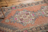 Stepped corner spandrel detail on distressed Oushak runner with dusty apricot and pink.
