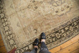 Texture of a vintage distressed Oushak rug in muted antique ivory and charcoal.