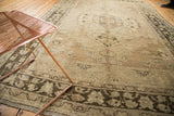 Aged texture of vintage distressed Oushak rug, with worn charcoal patterns and antique ivory field.