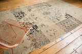 Faded charcoal motifs and soft abrash on a vintage distressed Oushak rug.