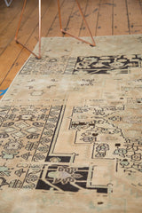 Distressed charcoal black and antique ivory Oushak carpet with intricate motifs and soft texture.