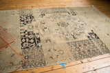 Distressed vintage Oushak rug with pronounced abrashes and muted ivory and charcoal patterns.