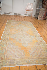 Distressed Oushak runner corner with rhythmic spandrels, serrated patterns, and saffron gold pile.