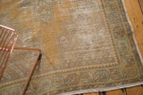 Distressed vintage Oushak rug runner showing saffron gold field, wear, and corner spandrels.
