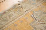 Vintage distressed Oushak rug pile showing even wear and saffron gold with pale mint green.