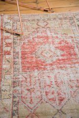 Distressed vintage Oushak runner texture, showing faded red, ivory, and charcoal geometric design.