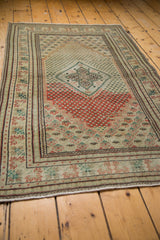 Vintage distressed Turkish Oushak rug, showing abrash, brick red, mint, and ivory tones.