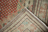 Distressed pile texture and secured fringe detail of the Vintage Oushak rug.