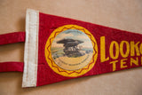 Detail of red felt flag featuring Umbrella Rock graphic, text, and yellow zigzag border.