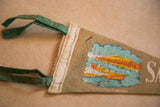 Bound edge of vintage felt flag showing green ties and colorful San Francisco boats.