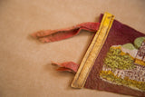 Vintage Worchester Massachusetts felt flag showing frayed reddish ties, yellow trim, and green imagery.