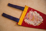 Dark blue felt ties and yellow binding on the red felt Onset pennant.