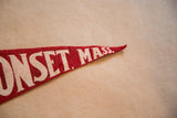 Red felt pennant tip with white 'MASS.' lettering and vintage wear.