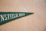 Green felt pennant detail, showing white 'ANSFIELD, OHIO' text and pointed end.