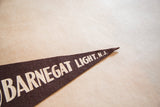Dark brown felt Barnegat Light pennant tip displaying 'LIGHT, N.J.' in white.