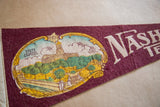 Vintage Nashville felt flag detail showing cream lettering on deep burgundy texture.