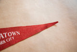 Vintage red felt flag pennant tip showing wear and partial text.