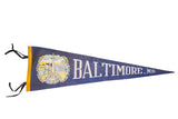Vintage deep blue felt Baltimore MD pennant flag with 1960s Washington Monument graphic.
