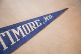 Pointed tip of the vintage blue Baltimore MD felt pennant with cream lettering.