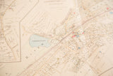 1930s Bedford Village map, aged ivory paper with streets, property plots, blue lake.