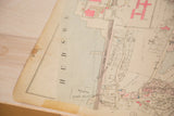 Vintage Hopkins map corner showing 'HUDSON' text and aged, torn paper.