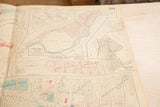 Detailed section of a vintage Peekskill map showing sub-plans and aged paper texture.