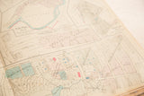 Close-up detail of street grids and hand-colored plats on a vintage Hopkins Peekskill map.