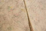 Close-up of vintage Hopkins map highlighting central crease and red handwritten markings.