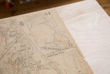 Aged paper and red-green notations on the vintage 1930s Hopkins map.