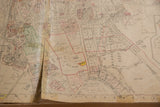 Aged vintage Hopkins map of Chappaqua, showing a prominent central tear across property details.
