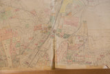 Vintage 1930s Hopkins Mt Kisco map showing central rip, aged creases, and pastel property sections.