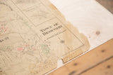 Aged bottom right corner of vintage 1930s Town of Bedford map, showing a large tear.