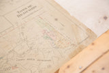 Worn corner of Vintage Hopkins map showing paper tears, tape, and age discoloration.