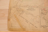Creased and torn corner of the vintage Purdys map, with visible repair tape.