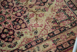 Detailed view of the traditional floral pattern and even pile on an antique Persian Kerman rug.
