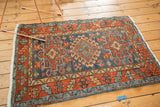 Vintage Karaja rug corner with madder root red geometric border and denim blue field.