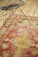 Distressed vintage Oushak rug pile with rich dusty cherry red and faded saffron yellow.