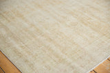 Distressed Oushak rug pile revealing knot heads, muted ivory and beige texture.
