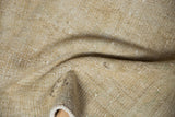Washed-out, distressed texture of the vintage Oushak rug with neutral tones.