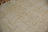 Distressed vintage Oushak carpet texture, highlighting washed-out pile and visible foundation.